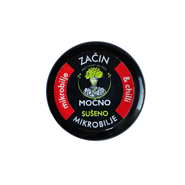 Close-up shot of the jar lid from above. The focus is on the black label with a red circle and graphics symbolizing the heat of chilli and the power of microgreens.